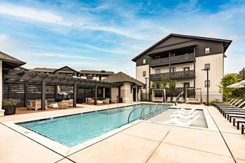 a swimming pool with a building in the background